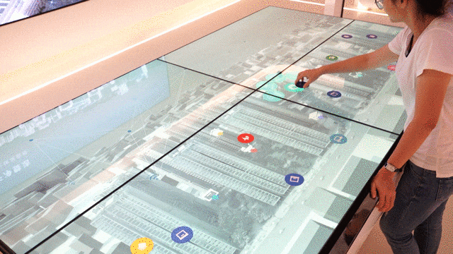A woman interacting with a virtual table navigating the city