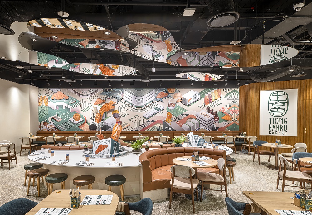 Tables and chairs in a restaurant with mirrors shaped like puddles on the ceiling