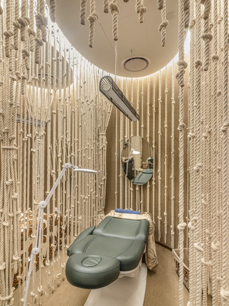 ropes hanging from a ceiling to form a cave in a treatment room for brow grooming