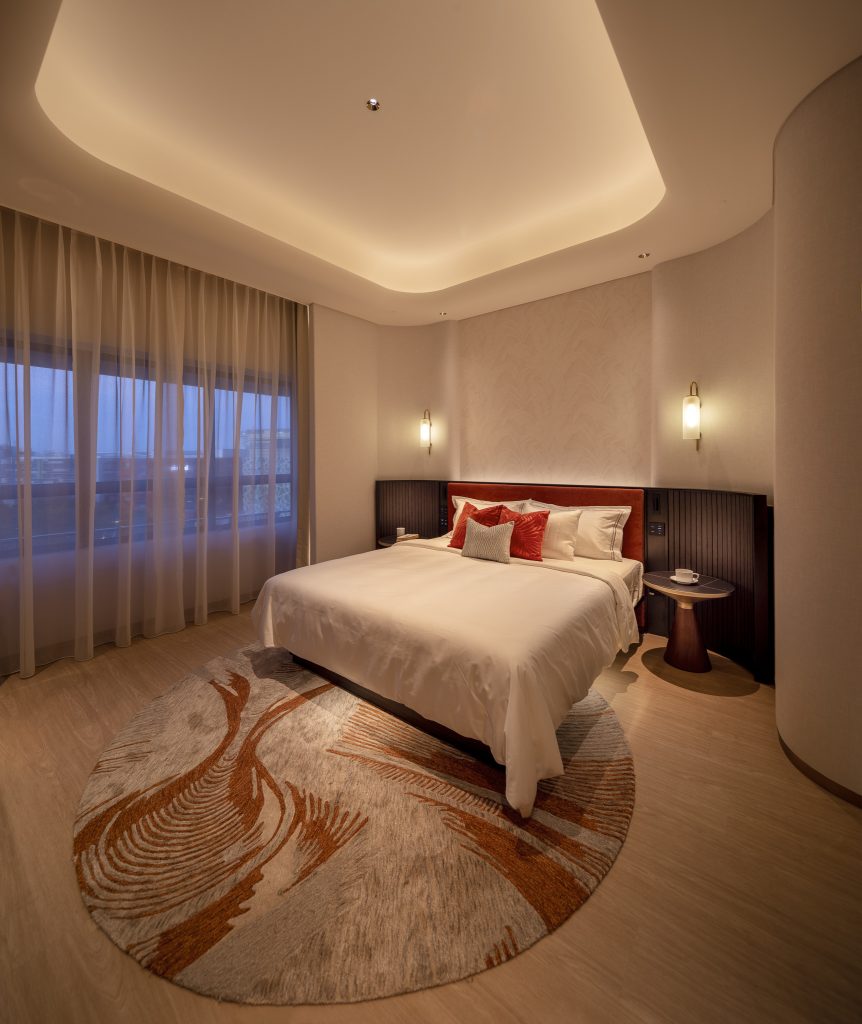 Bed by a window in a mock up hotel room