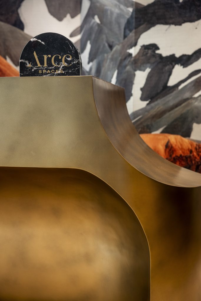 Close up of a metallic coloured reception counter which has a curved cut out corner